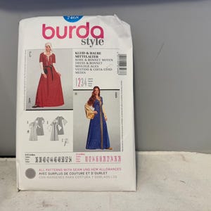 May include: A Burda Style sewing pattern for a medieval dress and bonnet. The pattern packet features illustrations of the finished garments in red and blue. The text includes the pattern number, size options, and multi-language instructions.