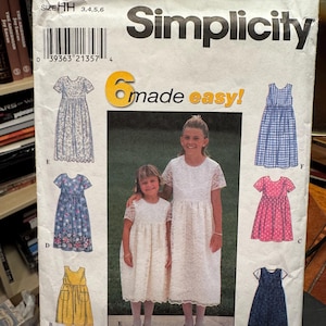 May include: A Simplicity 8030 sewing pattern envelope for sizes HH 3, 4, 5, 6. The front features the text 6 made easy! and displays illustrations of six different dress styles labeled A through F, alongside a photograph of two children wearing white lace dresses.