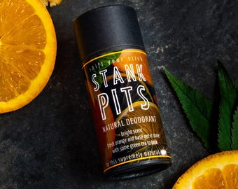 May include: A black deodorant stick with the words "shift your stick STANK PITS NATURAL DEODORANT" and a description of the scent: "bright scent fresh orange and basil get it done with some green tea to boot to this supremely natural".