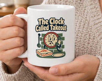 May include: A white ceramic mug featuring a graphic illustration of a cartoon clock character holding a telephone receiver. The text above reads The Clock Called Takeout. Below the clock is a pizza box and a plate against a green brick wall background.