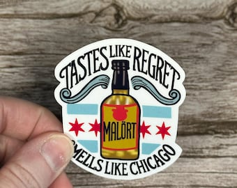 May include: A white sticker with the text "Tastes Like Regret, Smells Like Chicago" surrounding a yellow bottle of Malört. The bottle is centered on a blue and white striped background with red stars on each side.