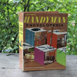 May include: A vintage "The Family Handyman Encyclopedia" book with a brown cover and a colorful illustration of tools and home improvement projects. The text on the cover reads "The Do-It-Yourself Guide".
