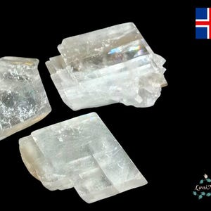 May include: Three clear, white selenite crystals with a layered, stacked structure. The crystals are translucent and have a slight iridescent sheen.