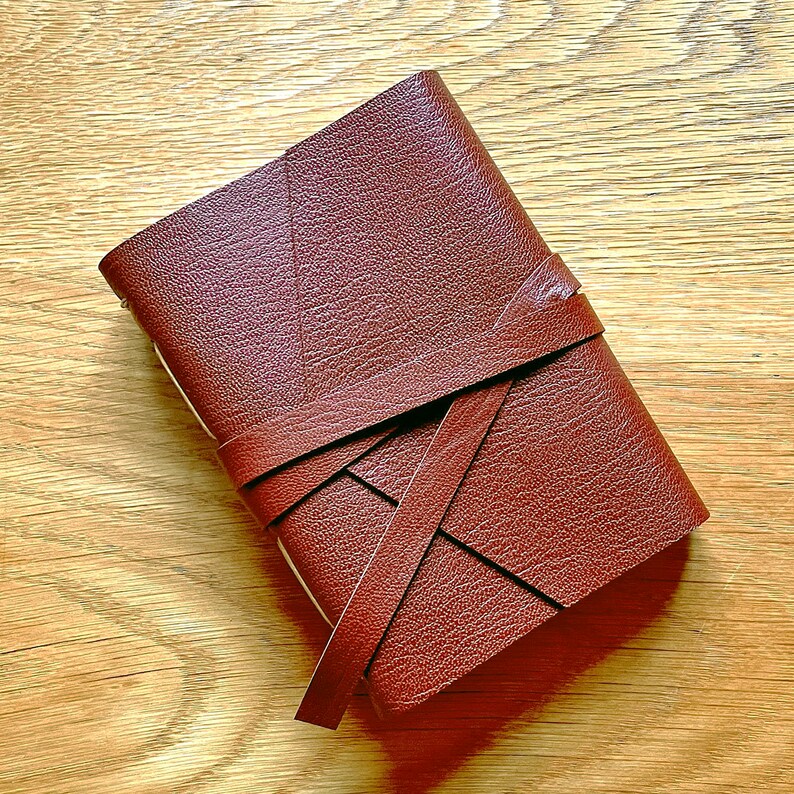 Medieval style brown leather journal with strap.