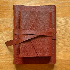 This A6 Small Oxblood Journal sits on top of the medium A5 version, for size reference.