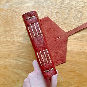 Leather Journal handmade in Oxblood brown leather with Tan Longstitch with Linkstitch exposed spine lay flat binding, and natural suede inner cover.