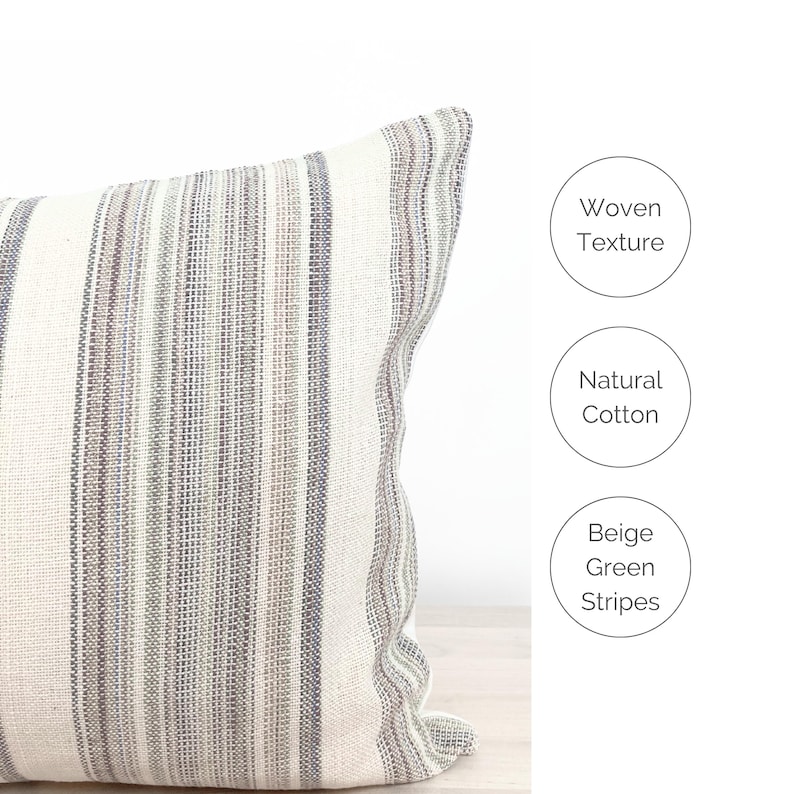 May include: Beige, green, and brown striped throw pillow with a woven texture. The pillow is made of natural cotton.