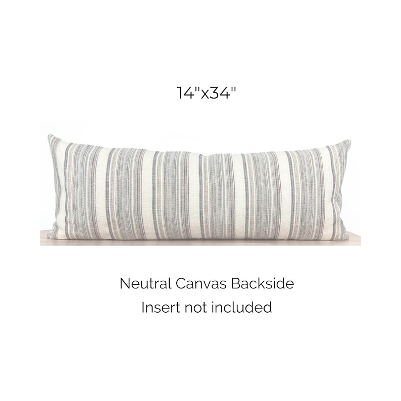 May include: A gray and white striped lumbar pillow with a neutral canvas backside. The pillow measures 14 inches by 34 inches. Insert not included.