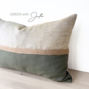 May include: A green and beige pillow with a jute trim. The pillow has the text "GREEN with Jute" printed on it.