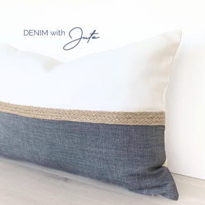 May include: A white pillow with a dark gray denim bottom and a jute trim. The pillow has the text "DENIM with Jute" on the top.