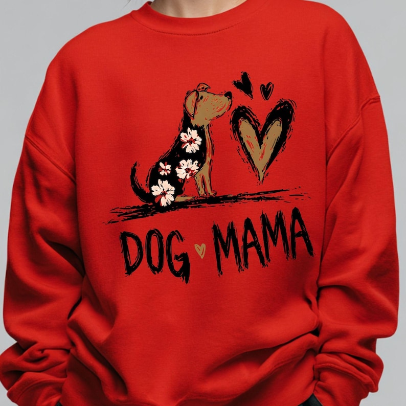 May include: Red sweatshirt featuring a dog illustration with floral patterns and a heart design. The words "DOG MAMA" are printed in black. The sweatshirt is a vibrant red colour.