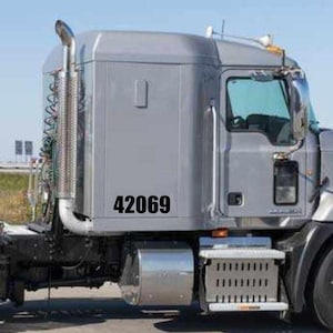 May include: A silver semi-truck with a black number "42069" on the side.