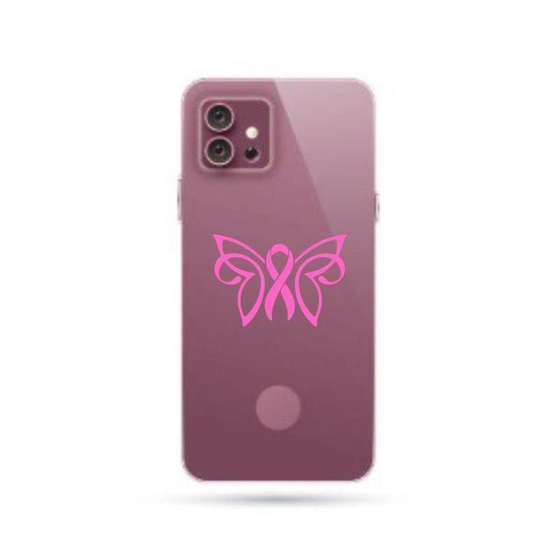 May include: A pink phone case with a pink butterfly design incorporating a ribbon. The butterfly has a pink ribbon in the center.