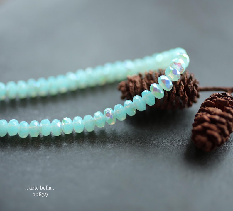 Semi translucent milky sky blue opaline glass with a 1/2 coat rainbow Aurora Borealis and fire polished finish .. lots of flash and sparkle .. great little spacer accent beads.
Mystic Sky Bits