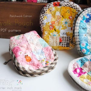 May include: A patchwork fabric pouch with a zipper closure. The pouch is made of different colored fabrics, including pink, blue, yellow, and white. The pouch is labeled "Sidewalk Pouch" and "Patchwork Edition".