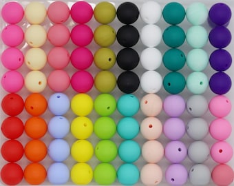 May include: A collection of 36 colorful silicone beads, each with a smooth, round shape. The beads are arranged in rows, showcasing a variety of vibrant hues, including red, orange, yellow, green, blue, purple, pink, and white.