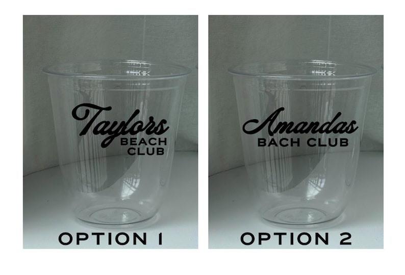 May include: Two clear plastic cups with black text. One cup reads "Taylors BEACH CLUB" and the other reads "Amandas BACH CLUB". The cups are empty and have a simple, clean design, suitable for parties or events.