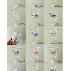 May include: Clear plastic cups with the text "Taylor's Beach Club" printed in various colors, including green, orange, white, black, blue, and red. The cups are arranged in rows, showcasing the different color options available.