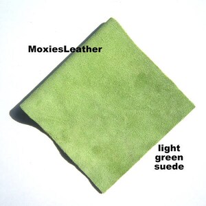 May include: A light green suede leather square. MoxiesLeather.