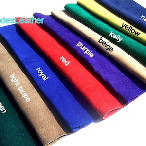 May include: A variety of leather swatches in different colors, including dark green, light taupe, royal blue, red, purple, beige, kelly green, yellow, and navy. The swatches are arranged in a fan shape, with the darkest color at the bottom and the lightest color at the top. The text "MoxiesLeather" is visible in the top left corner of the image.