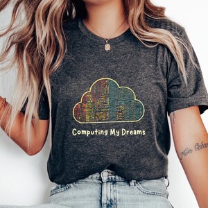 May include: A dark heather grey t-shirt with a colourful cloud graphic and the text "Computing My Dreams".