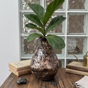 May include: A handmade wooden sign with the text "Welcome to our home" in a handwritten style. The sign is painted white with a dark stained wooden frame. The sign measures approximately 12 inches wide and 8 inches tall.