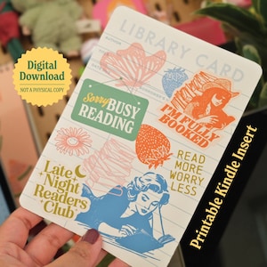 May include: Printable Kindle insert with a library card design. The card features illustrations of books, flowers, strawberries, and a woman reading. The text on the card includes "Sorry Busy Reading", "I'm Fully Booked", "Late Night Readers Club", and "Read More Worry Less".