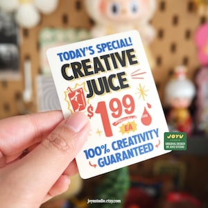 May include: A rectangular sticker with the text "TODAY'S SPECIAL! CREATIVE JUICE" in black and white. The sticker also includes the price "&pound;1.99 EA" and the phrase "100% CREATIVITY GUARANTEED".