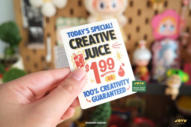 May include: A rectangular sticker with the text "TODAY'S SPECIAL! CREATIVE JUICE" in black and white. The sticker also includes the price "&pound;1.99 EA" and the phrase "100% CREATIVITY GUARANTEED".