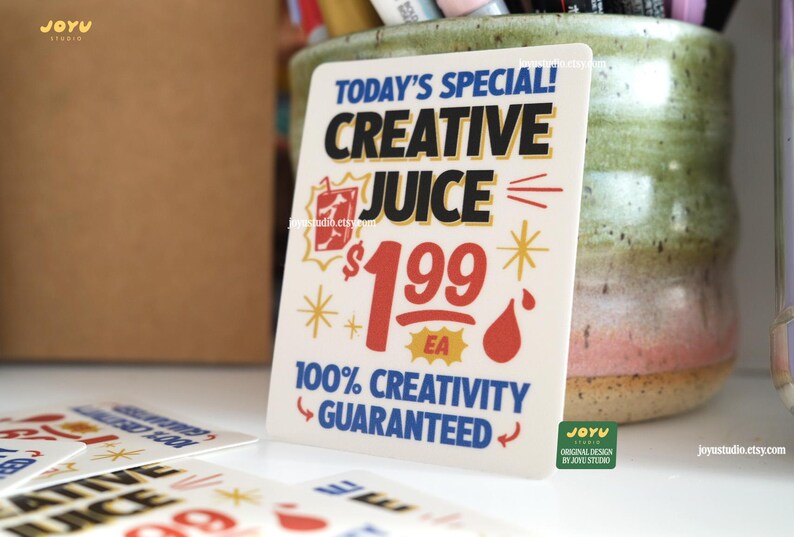 May include: A white rectangular sign with the text "TODAY'S SPECIAL! CREATIVE JUICE $1.99 EA 100% CREATIVITY GUARANTEED" in blue, red, and yellow. The sign has a cartoon-style design with a drink and starbursts.