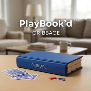 May include: A blue Cribbage game set in a book-like design. The game includes a blue book-shaped board, playing cards, and pegs. The text "PlayBook'd" and "CRIBBAGE" are visible on the game.