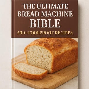 Könnte beinhalten: Ein Kochbuch mit dem Titel "THE ULTIMATE BREAD MACHINE BIBLE" und dem Untertitel "500+ FOOLPROOF RECIPES". Das Buch zeigt ein Brot und eine Scheibe auf einem Holzschneidebrett. Das Brot ist goldbraun.