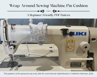 May include: A white sewing machine with a blue and white floral pin cushion attached. The text "Wrap-Around Sewing Machine Pin Cushion" and "A Beginner-Friendly PDF Pattern" are at the top. The sewing machine has the brand name "JUKI" on it.