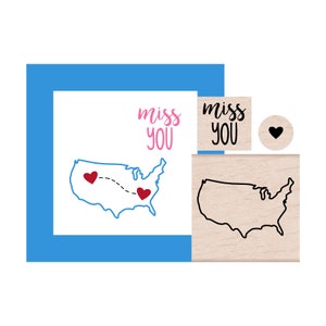 May include: A set of three wooden stamps featuring a map of the United States with two hearts and the text "miss you".