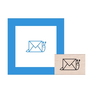 May include: A wooden rubber stamp with a black line drawing of a snail carrying a letter envelope. The snail has two antennae.