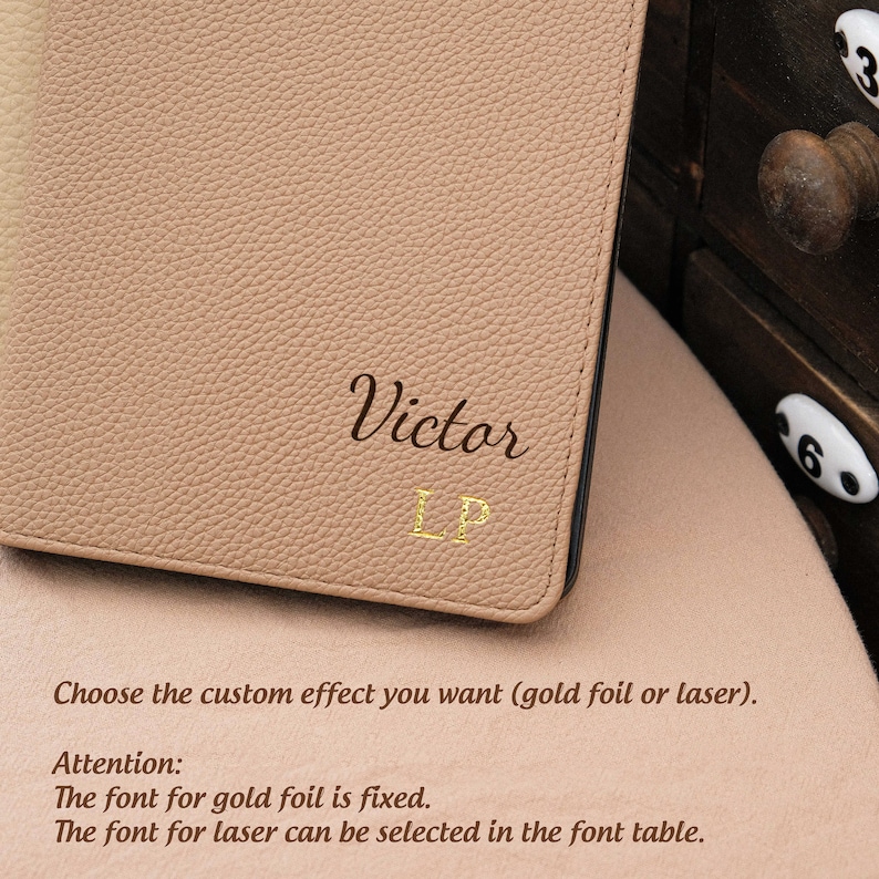 May include: A light brown leather notebook with the name "Victor LP" embossed in gold foil. The text "Choose the custom effect you want (gold foil or laser). Attention: The font for gold foil is fixed. The font for laser can be selected in the font table." is printed below the embossed name.