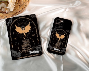 May include: Black phone case and tablet featuring a gold dragon illustration above a stack of books. The text includes "Brittney" and "The Dragon Rider's Codex". The design is set against a black background with celestial accents.