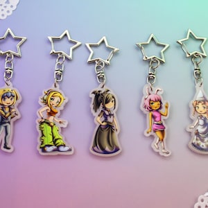 May include: Five acrylic keychains featuring illustrated anime-style characters, each attached to a silver-colored star-shaped metal clasp. The characters include a figure in yellow overalls, a person in green pants, a dark-dressed figure, a pink-haired character, and a figure in a white gown.