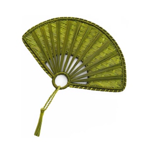 May include: A handcrafted fan in shades of green, featuring a woven design. The fan has a circular handle and a tassel. The fan's frame is outlined with a darker green thread. The fan is set against a white background.