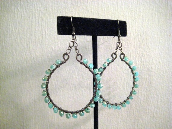 Items similar to Hammered gunmetal horseshoe earrings with blue ...