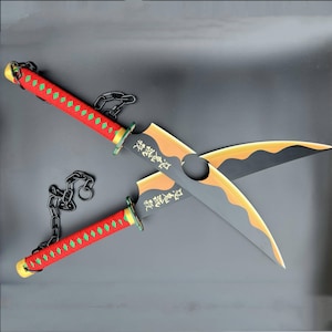 May include: A pair of black and gold swords with red and green handles and black chains. The swords have Japanese characters on them.