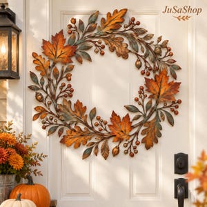 May include: A circular wreath featuring metallic autumn leaves in shades of orange, copper, and bronze, interspersed with small round berries and acorns. The design includes intricate branch detailing with a weathered patina finish.