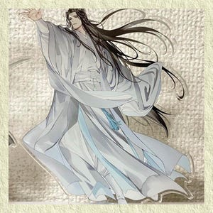 May include: An acrylic stand featuring a character in flowing white robes with long black hair. The character is depicted with an outstretched arm, and a blue tassel hangs from the waist. The artwork has a soft, watercolor-like style.