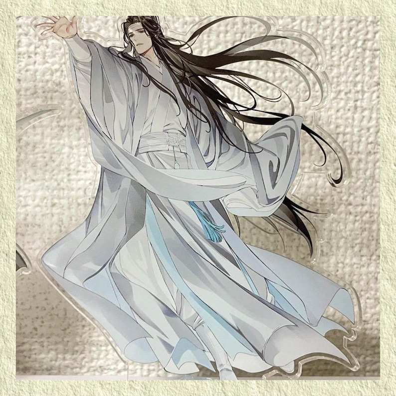 May include: An acrylic stand featuring a character in flowing white robes with long black hair. The character is depicted with an outstretched arm, and a blue tassel hangs from the waist. The artwork has a soft, watercolor-like style.