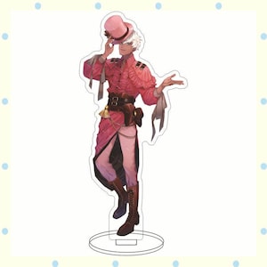 May include: A pink and red anime-style figure of a person wearing a pink top hat, ruffled shirt, and long coat. The figure is standing on a clear circular base. The figure has white hair and brown boots.