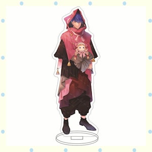 May include: A full-body acrylic standee featuring a character with blue hair and a pink hooded cloak. The character holds a doll. The standee has a circular base and is set against a white background.