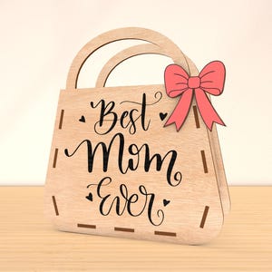 May include: Wooden cutout of a handbag with a pink bow and the text "Best Mom Ever" in black script.