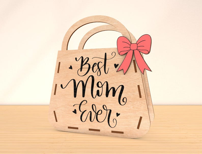 May include: Wooden cutout of a handbag with a pink bow and the text "Best Mom Ever" in black script.
