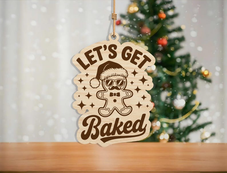 May include: Wooden Christmas ornament featuring a gingerbread man wearing sunglasses and a Santa hat. The text "LET'S GET BAKED" is above and below the gingerbread man. The ornament is hanging by a natural twine string.