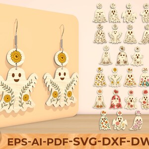 Puede incluir: Pendientes de fantasma de madera con diseños de girasoles y flores. Los pendientes tienen una parte superior redonda con un girasol y una parte inferior en forma de fantasma con una cara sonriente y detalles florales. También se muestran diseños adicionales de pendientes de fantasma.
